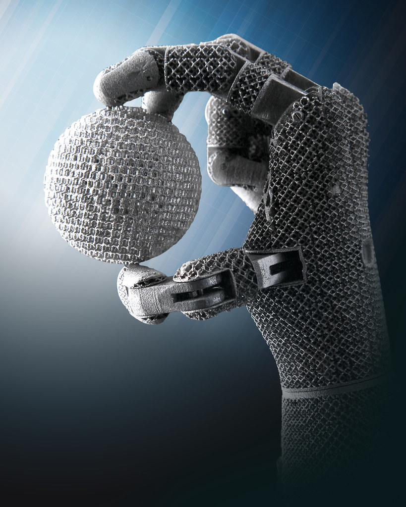 Historical Oak Ridge robotic hand holding a textured sphere.